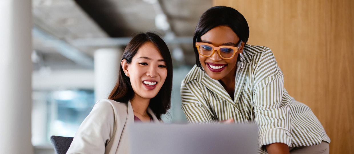 Two woman working on a laptop