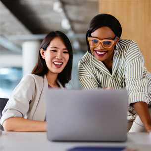 Two women working on a laptop